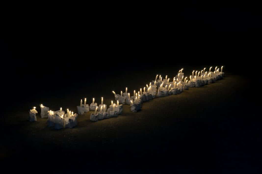 A group of white candles sitting on top of a table