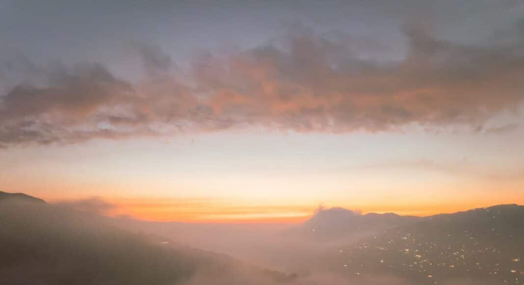 A view of a city in the distance from a hill