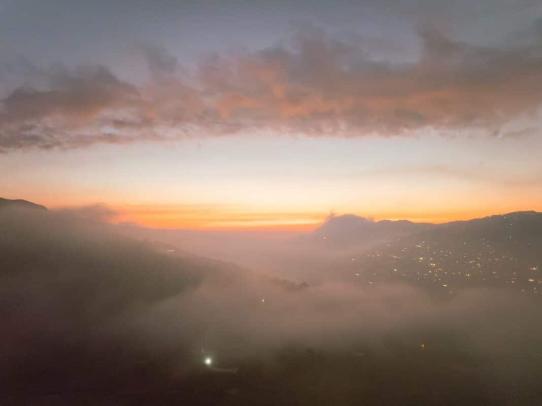 A view of a city in the distance from a hill