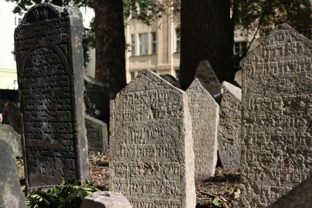 A cemetery with headstones and trees in the background