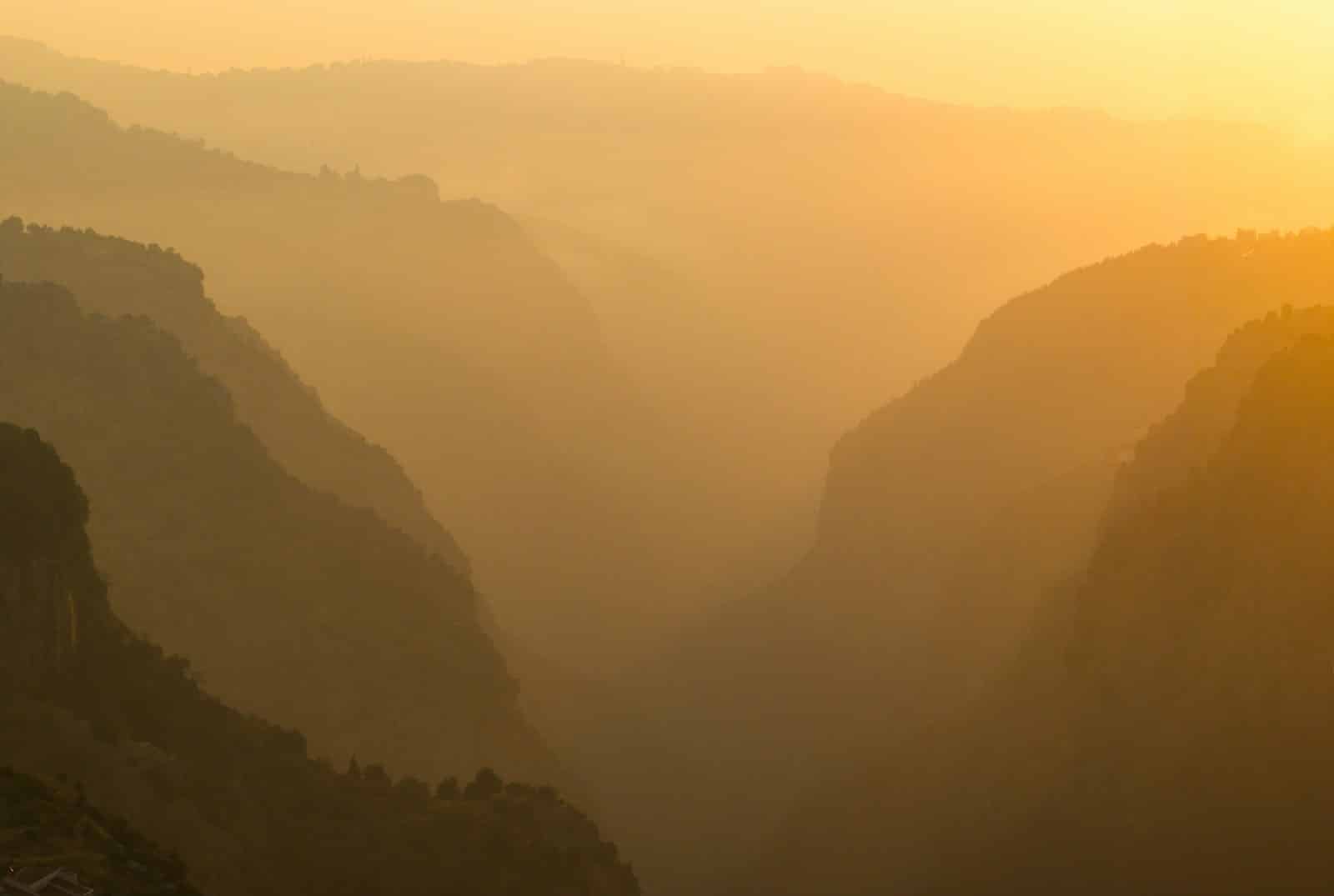 A view of a valley with mountains in the background