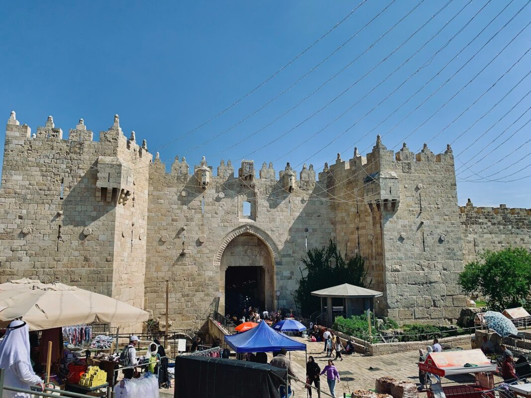 a castle like structure with people walking around it