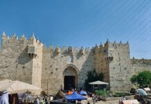 a castle like structure with people walking around it