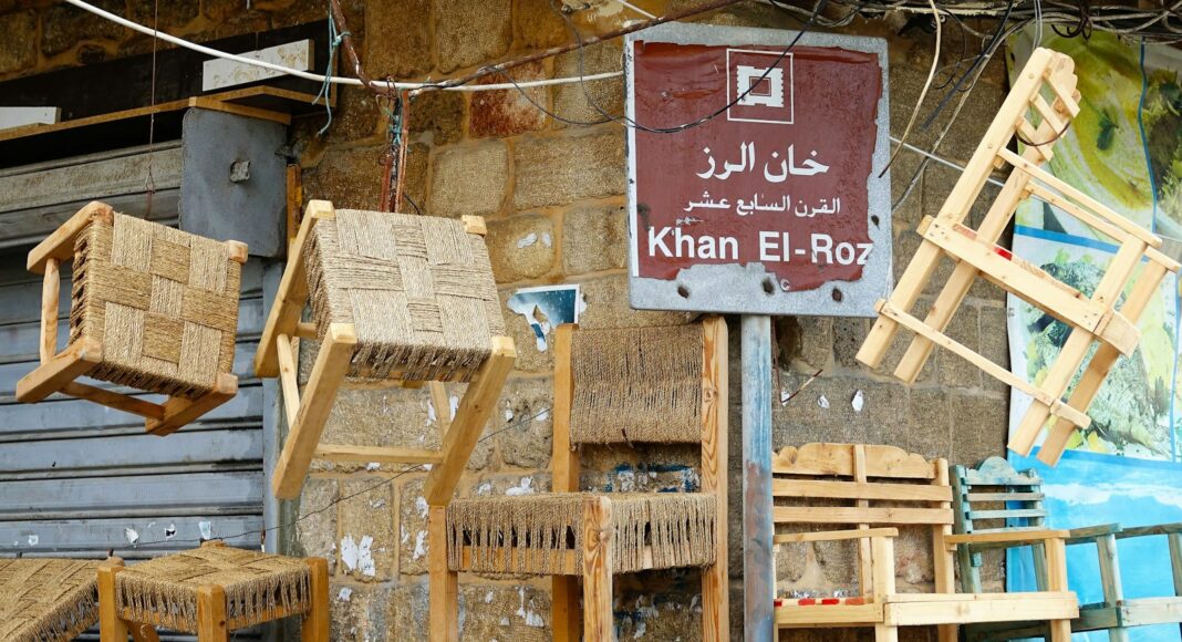 a bunch of wooden chairs hanging on a wall
