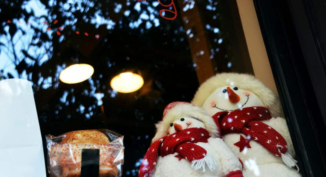 white snowman plush toy on glass window