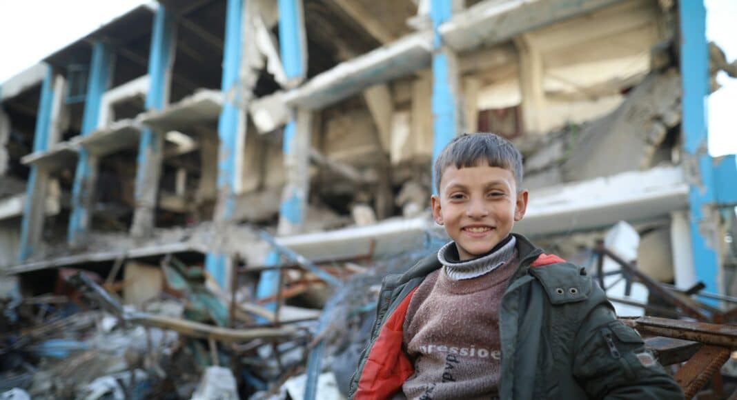 A man standing in front of a pile of rubble