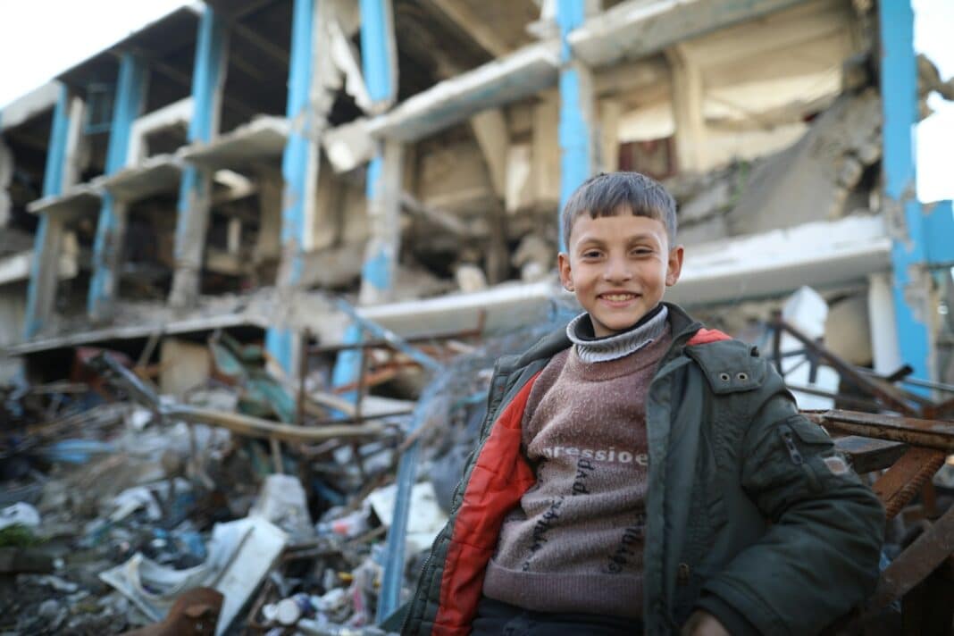 A man standing in front of a pile of rubble