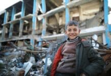 A man standing in front of a pile of rubble