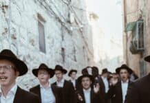group of men walking on concrete road