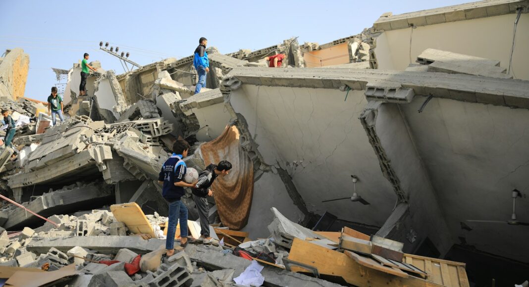 a group of people standing next to a collapsed building