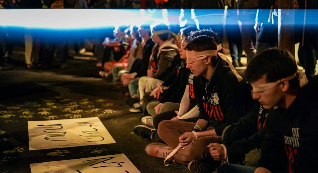A group of people sitting on the ground
