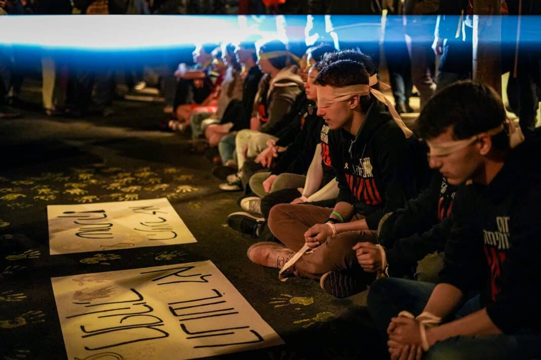 A group of people sitting on the ground
