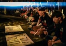 A group of people sitting on the ground
