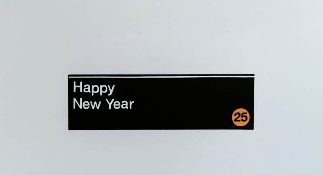 A sign that says happy new year hanging on a wall