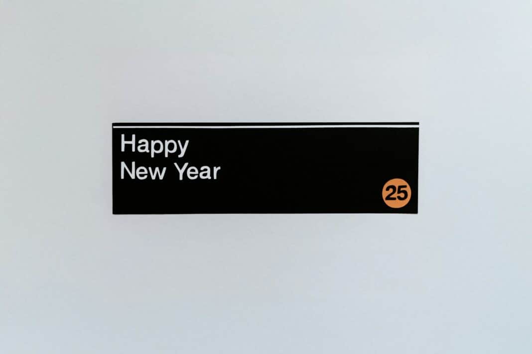 A sign that says happy new year hanging on a wall