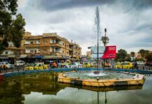 a fountain in the middle of a city square