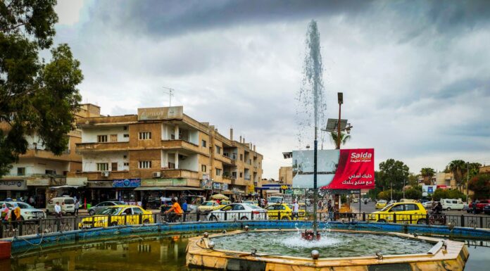 a fountain in the middle of a city square