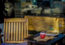 a table with a chair and a window with a view of a street