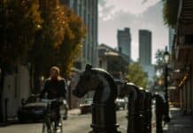 a person riding a bike on a city street