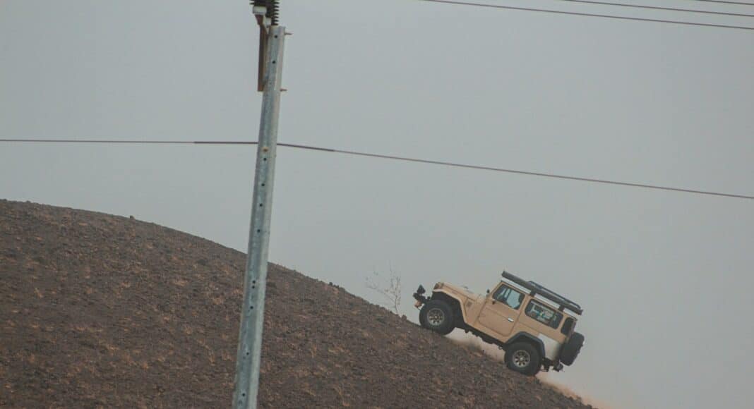 brown and black suv on brown dirt road during daytime