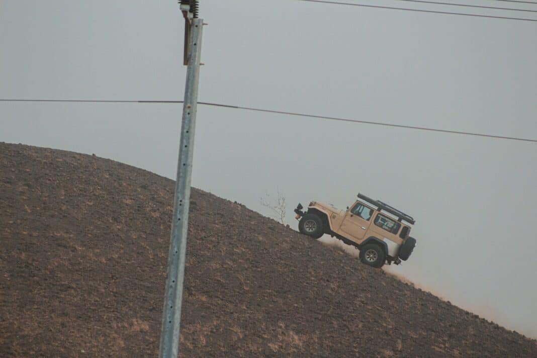 brown and black suv on brown dirt road during daytime