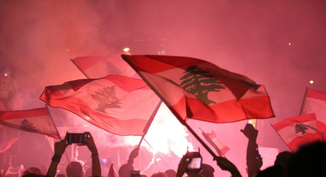 people raising flags during night time