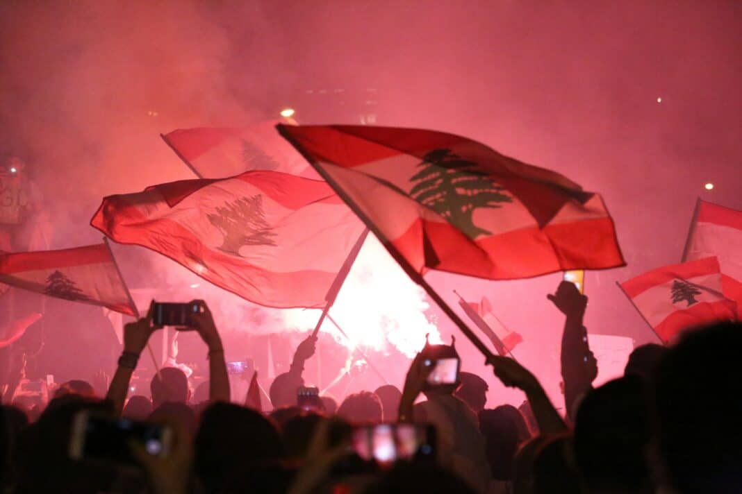 people raising flags during night time