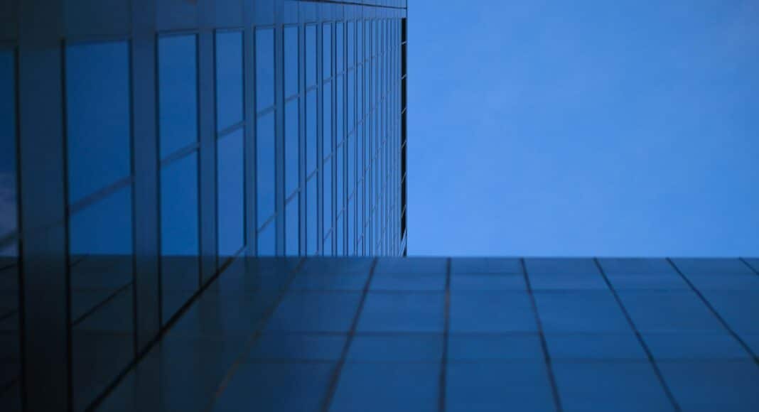 a tall building with a blue sky in the background