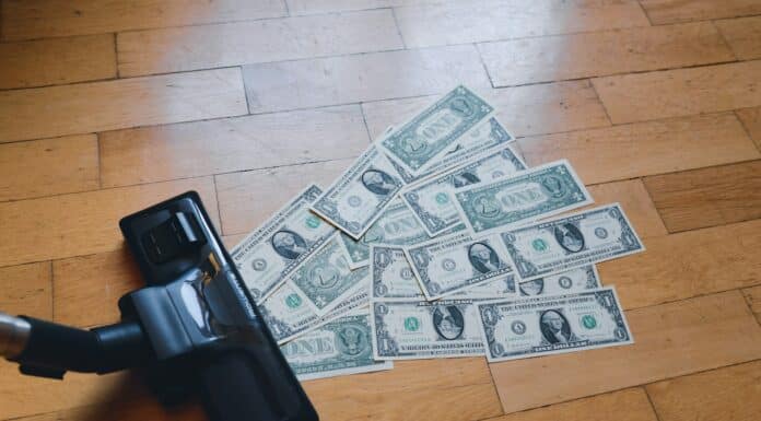 a pile of money sitting on top of a wooden floor