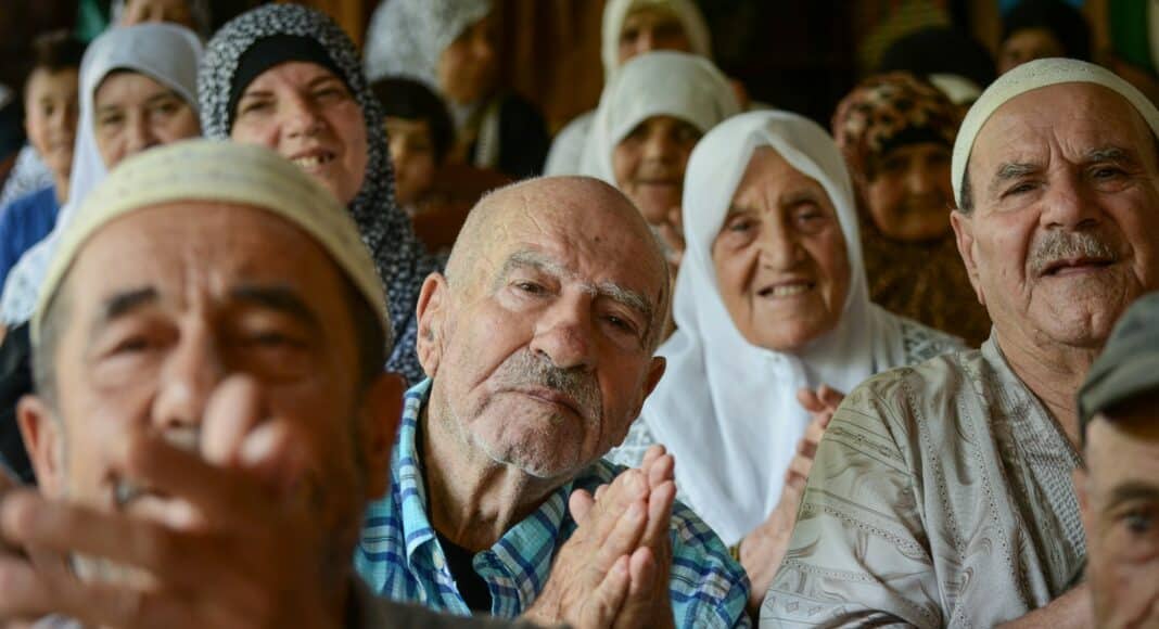 A group of people sitting next to each other