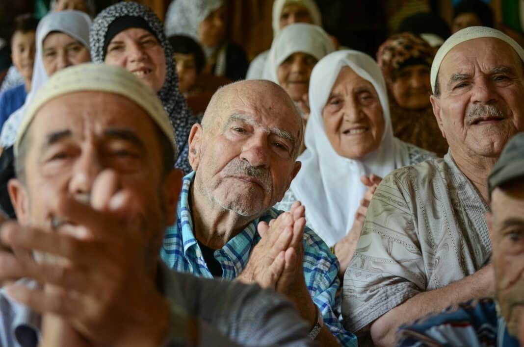 A group of people sitting next to each other