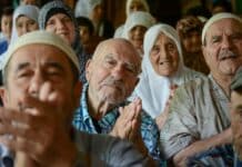 A group of people sitting next to each other
