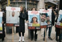 A group of people holding up signs on the street