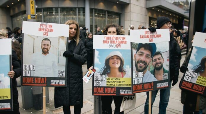 A group of people holding up signs on the street