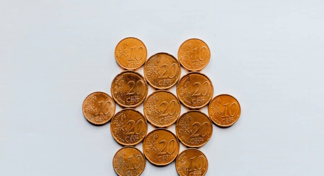gold round coins on white surface