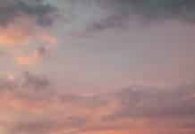 a couple of people standing on top of a rocky beach