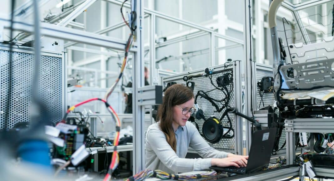 woman in white long sleeve shirt using black laptop computer