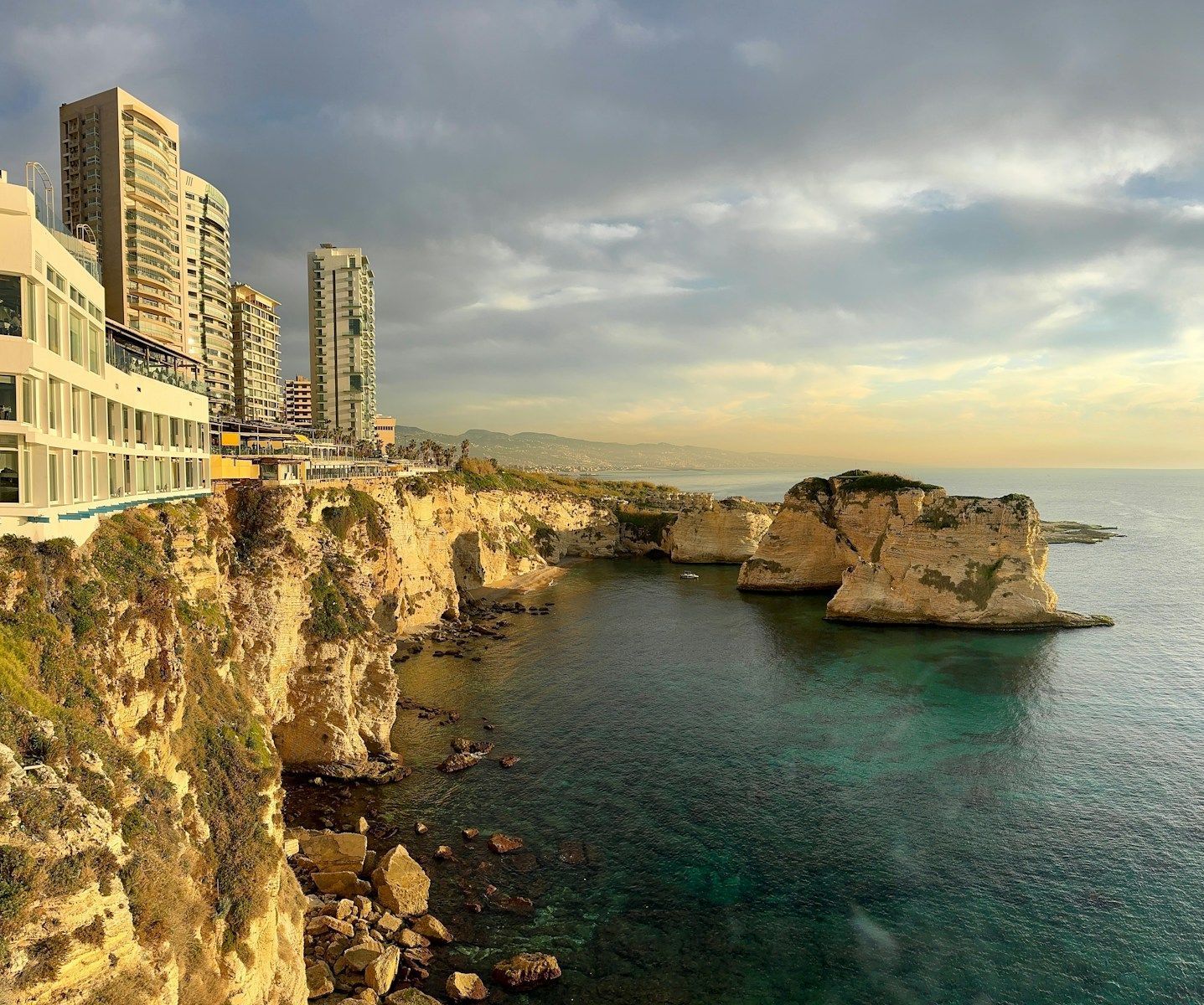 A large body of water next to a cliff