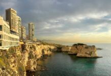A large body of water next to a cliff