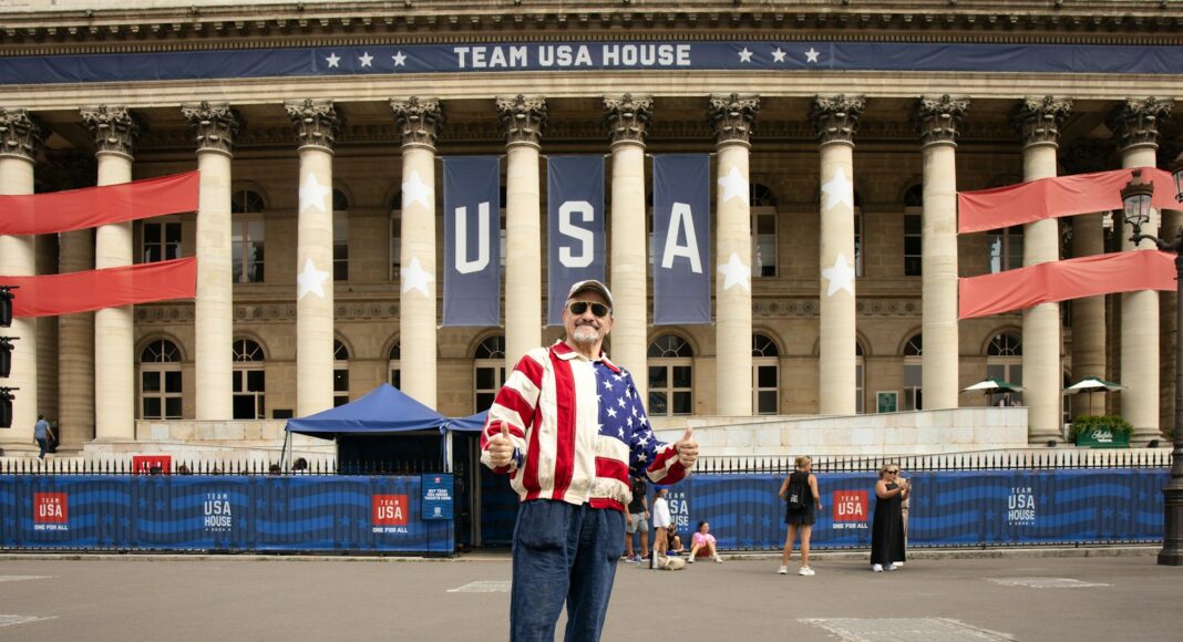 A man standing in front of a large building