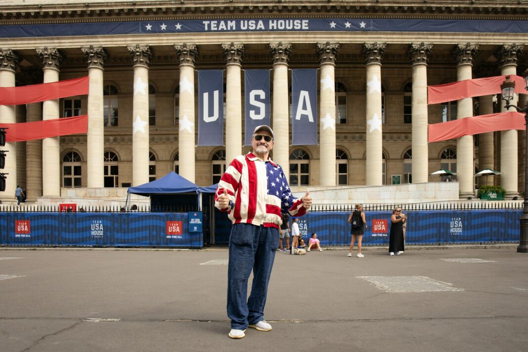 A man standing in front of a large building
