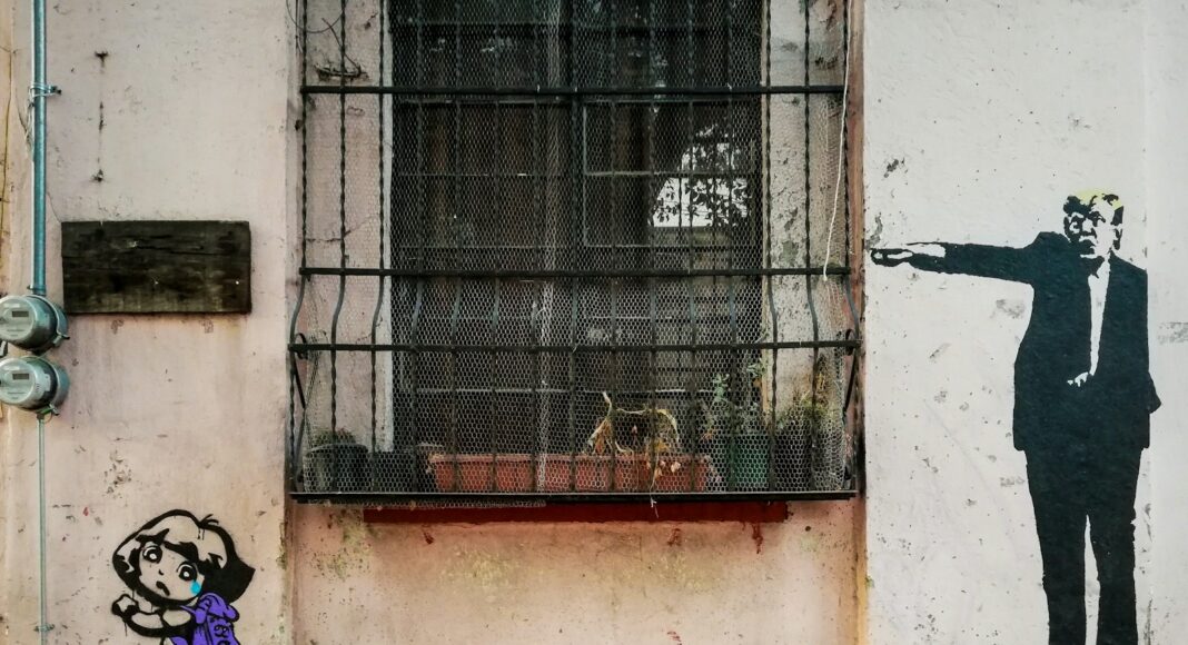 black metal window grill on white concrete wall