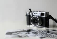 black and gray film camera near printed photos