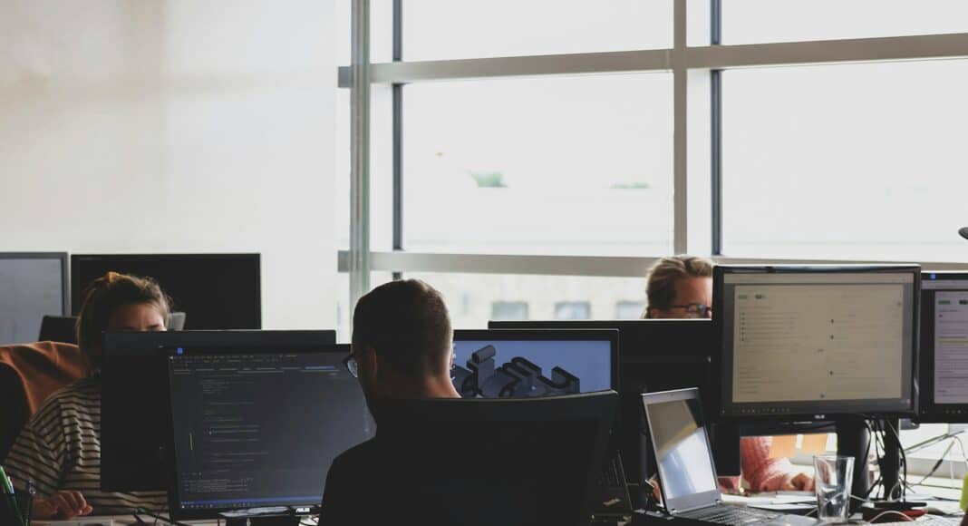 people sitting on chair in front of computer monitor
