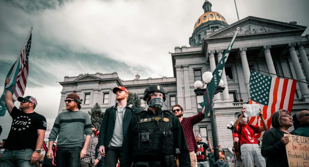 group of men in black uniform standing on green grass field during daytime