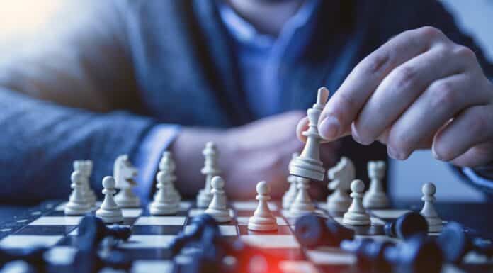 depth of field photography of man playing chess