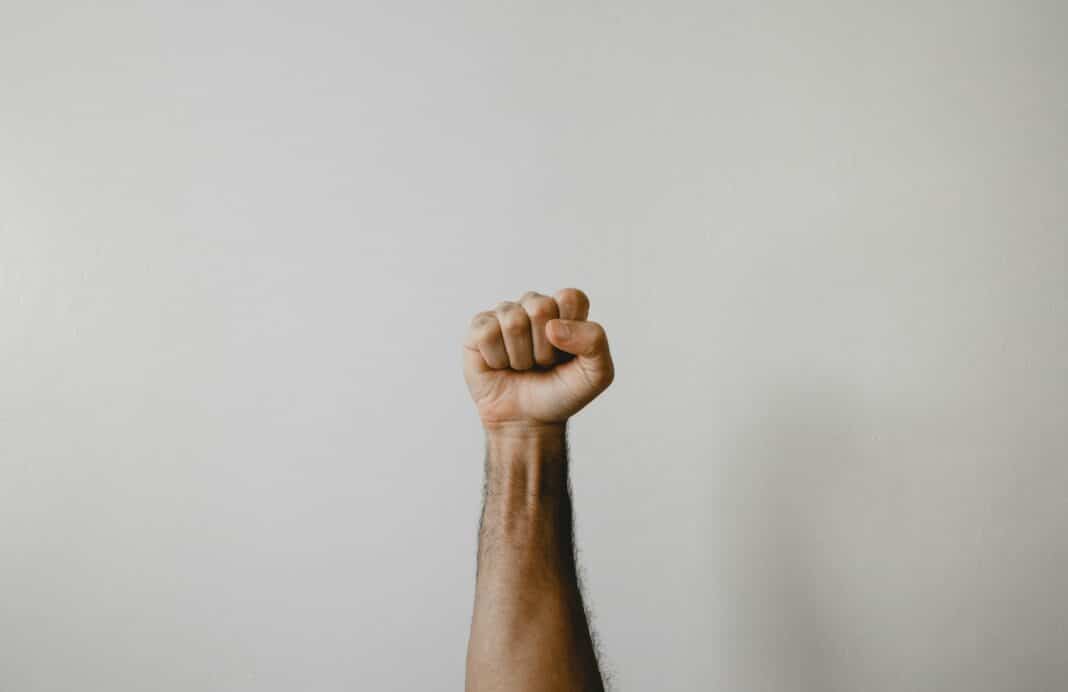 persons right foot on white wall