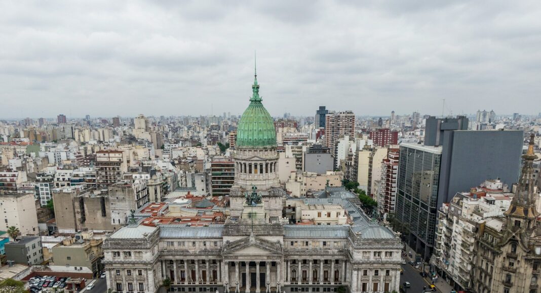 cars on road near city buildings during daytime