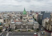cars on road near city buildings during daytime