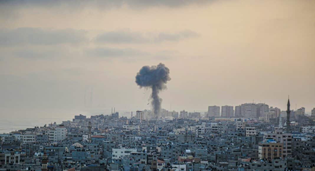 smoke billows from a factory in a city
